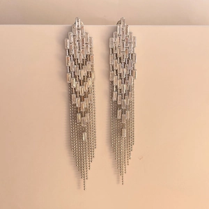 Macro shot of zircon inlaid long tassel drop earrings with cascading silver bead chains