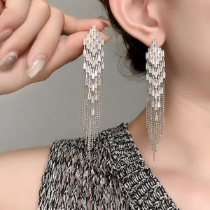 Detail of long fringe earrings with cubic zirconia and 18K gold plated beaded chains