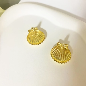 Elegant gold-plated shell stud earrings with a glossy ribbed texture on white display