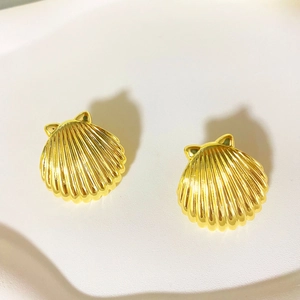Elegant gold shell stud earrings with cute cat ear design on a neutral textured surface