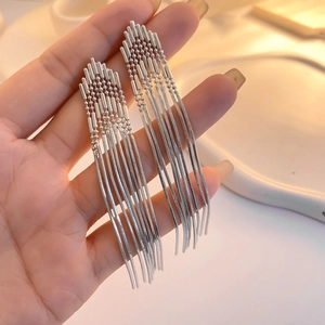 Detailed view of silver long tassel earrings with snake chain and geometric bead accents