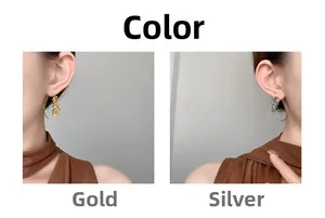 Detail of leaf earrings in gold and silver showing hollow veins and long hooks
