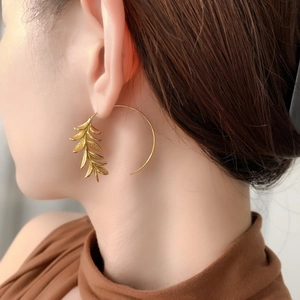 Elegant 18K gold-plated floral leaf drop earrings on model for a sophisticated look