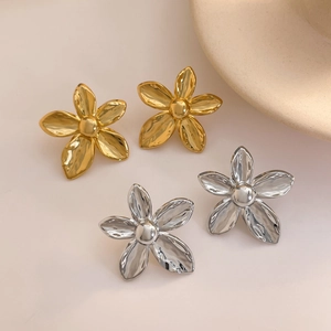 Polished 18K gold and silver plated flower stud earrings in a minimalist scene