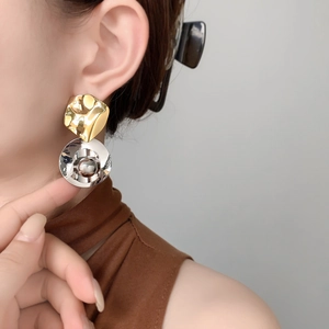 Boucles d'oreilles plissées bicolores or et argent en cuivre plaqué or 18 carats sur modèle