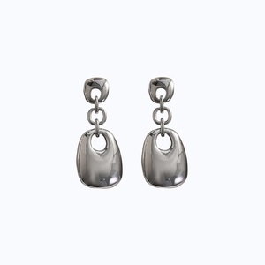 Detailed view of polished silver geometric dangling earrings with large hollow oval drop