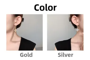 Detail showing long chain tassel earrings with clover-shaped zircon in gold and silver finish
