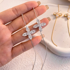 Detail of silver long chain tassel earrings with marquise-cut zircon flower petals
