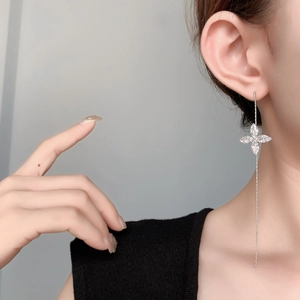 Elegant silver long tassel drop earrings with zircon clover on female model