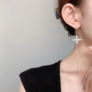 Close-up of long tassel silver chain earrings with marquise-cut zircon flower charms