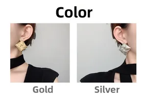 Detail of square gold and silver stud earrings showing fine woven metal texture details