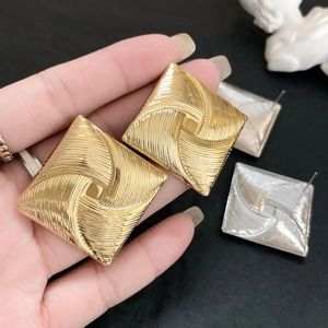 Chic square gold and silver stud earrings with radial windmill texture and metallic finish