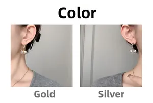 Detailed comparison of gold and silver bow stud earrings with blue crystals on model