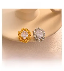 Detail view of oval flower zircon earrings in gold and silver finish with crystal