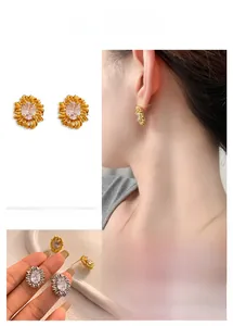 Macro detail of oval zircon sunflower earrings in gold and silver finish alloy