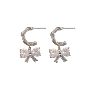Sparkling silver bow-knot drop earrings featuring textured C-shape hoops and crystals