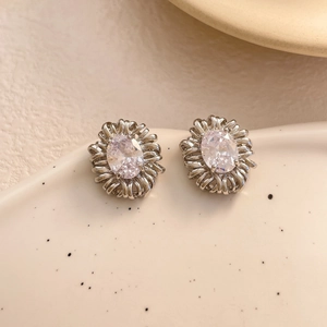 Detail showing vintage oval zircon stud earring with intricate woven sunflower metal frame