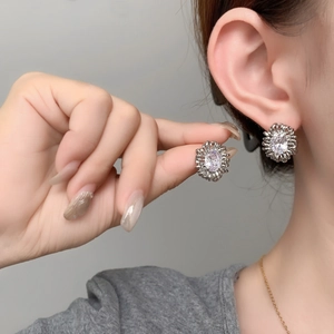 Macro view of sunflower stud earrings with oval cubic zirconia and silver finish