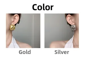 Detail of square vintage textured stud earrings in gold and silver finish on a model