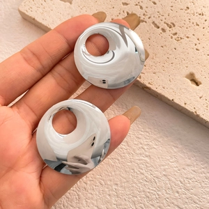Polished silver geometric round hollow earrings with a reflective mirror finish design