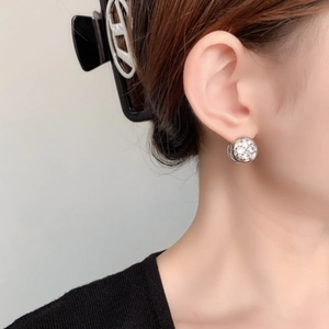 Elegant gold plated zircon flower hoop earrings worn by a model in a side profile view