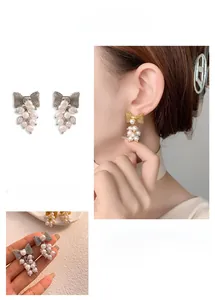 Detailed view of elegant bow earrings featuring cascading white pearl cluster drops