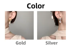 Detail view of pearl cluster earrings with metallic bows in gold and silver finishes