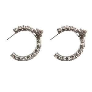 Chunky silver hoop earrings featuring square zircon stones and a detailed metal flower accent
