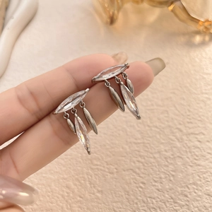 Close-up of elegant leaf tassel earrings featuring marquise-cut cubic zirconia in silver