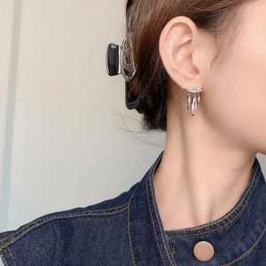 Elegant leaf tassel stud earrings with sparkling zircons worn by a model in close-up