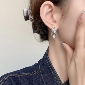Elegant silver tassel earrings with marquise cubic zirconia on a female model