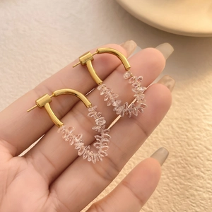 Elegant gold U-shaped hook earrings featuring shimmering clear zircon stone clusters