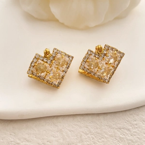 Detail of 18K gold plated earrings with champagne square zircon and pave white stones