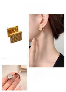 Detail view of square hoop earrings featuring pavé cubic zirconia in gold and silver finishes