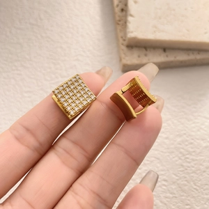 Close-up of gold square hoop earrings featuring micro-pave white cubic zirconia stones