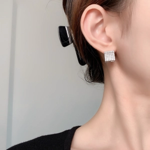 Fashionable silver square hoop earrings with sparkling micro-paved zircons on model