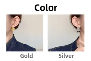 Detail view of 18K gold plated flower earrings with cubic zirconia and textured finish