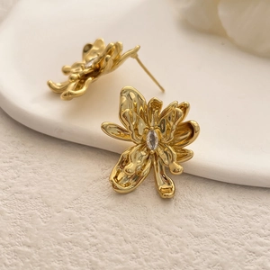 Macro shot of 18K gold plated flower earrings with sparkling center cubic zirconia