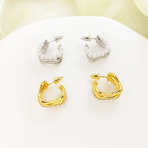 Elegant gold and silver C-shaped stud earrings with inlaid pearls and sparkling cubic zirconia