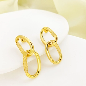 Irregular gold oval earrings with nested double ring design and textured finish
