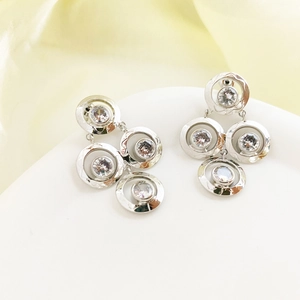 Silver geometric drop earrings with sparkling zircon crystals in a layered ring design