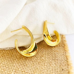 Polished golden wide curved stud earrings in a minimalist geometric design for women