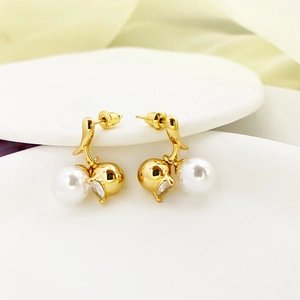 Elegant 18K gold plated ball earrings with pearls and crystals on a white plate