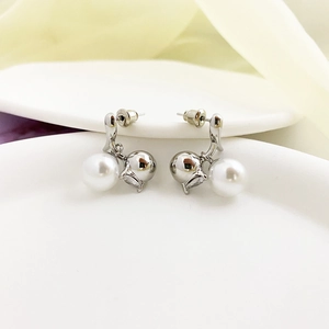 Detail of silver spherical studs with white pearl and mirrored metal ball design