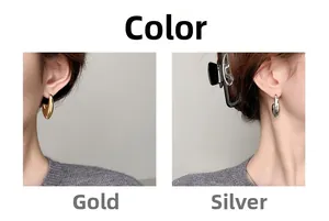 Polished hollow drop hoop earrings in gold and silver finish shown on a model