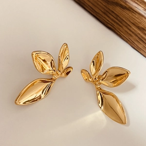 Elegant gold leaf stud earrings with a polished finish in a minimalist nature-inspired design