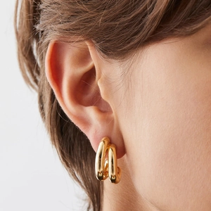 Polished gold triple hoop earrings in a minimalist C-shape design for a modern look