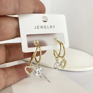 Golden double hoop earrings with heart-shaped pendants and sparkling cubic zirconia stones