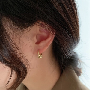 Minimalist gold S925 silver hoop earring with pavé zircon charm shown on model