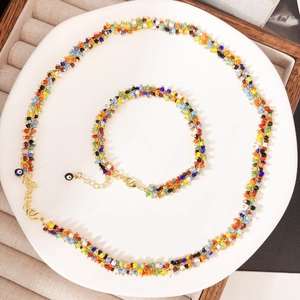 Detail of colorful bohemian seed bead necklace and bracelet set with evil eye charms